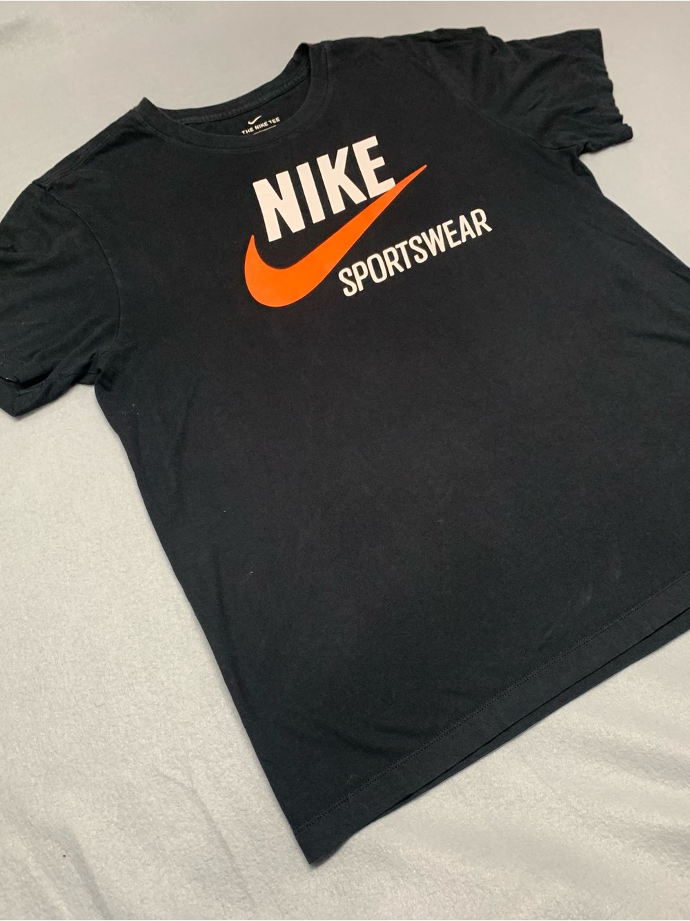 Nike Black Short-Sleeve Tee with Orange Swoosh and White Logo